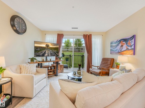 Spacious living area featuring light-toned walls and wood-finish flooring - 1103 2 Augustine Crescent, Sherwood Park, AB 