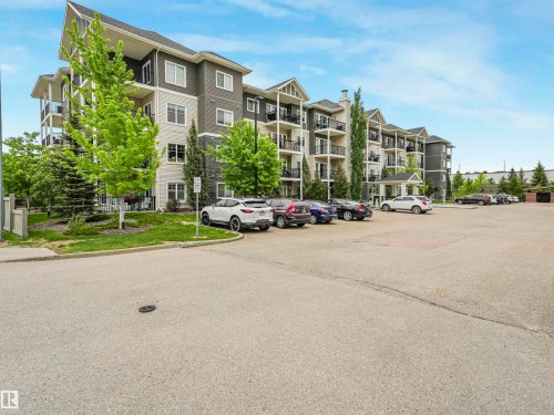 Multi-level residential building featuring a gabled roofline, dark siding, and light-colored panels - 1103 2 Augustine Crescent, Sherwood Park, AB 