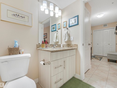 Bathroom vanity featuring a speckled countertop, undermount sink, and light wood-finish cabinetry - 1103 2 Augustine Crescent, Sherwood Park, AB 