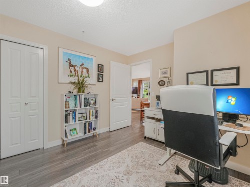Interior space featuring wood-finish flooring, light-toned wall paint, and white trim - 1103 2 Augustine Crescent, Sherwood Park, AB 