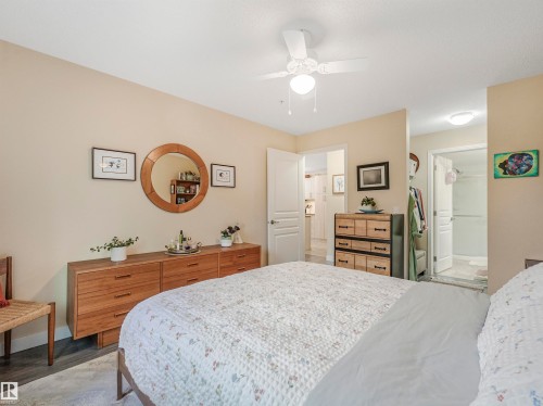 Bedroom featuring neutral wall paint, wood-finish flooring, and a ceiling fan with integrated lighting - 1103 2 Augustine Crescent, Sherwood Park, AB 