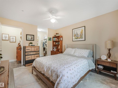 Bedroom featuring wood-finish flooring, a light-colored ceiling fan, and neutral wall tones - 1103 2 Augustine Crescent, Sherwood Park, AB 