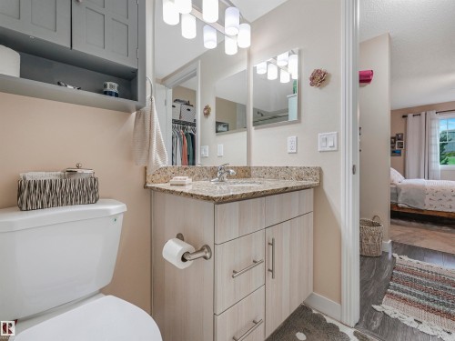 Bathroom featuring a light wood-finish vanity with a granite-style countertop and undermount sink - 1103 2 Augustine Crescent, Sherwood Park, AB 