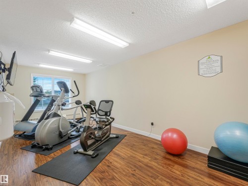 Fitness area featuring wood-finish flooring and neutral-toned walls - 1103 2 Augustine Crescent, Sherwood Park, AB 