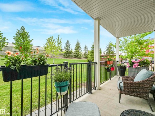 Covered patio featuring a concrete surface and a black metal railing - 1103 2 Augustine Crescent, Sherwood Park, AB 