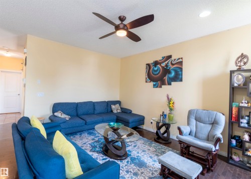 Living area featuring wood-finish flooring, recessed lighting, and a ceiling fan - 1840 56 Street, Edmonton, AB 