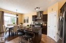 Kitchen island with a dark countertop and integrated sink - 1840 56 Street, Edmonton, AB 