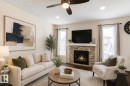 Living area featuring a gas fireplace with stacked stone surround and white mantle - 1840 56 Street, Edmonton, AB 
