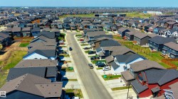 Residential street with multiple homes featuring varied architectural styles and rooflines - 