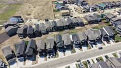 Aerial perspective showcasing a residential development with numerous single-family homes - 