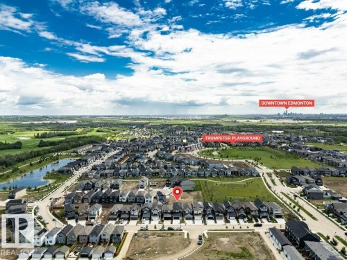 Aerial perspective showcasing a residential community with contemporary homes, green spaces, and a nearby body of water - 13007 213 Street, Edmonton, AB 
