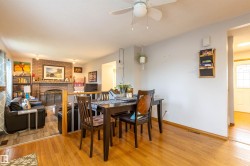 Dining area featuring wood-finish flooring and a ceiling fan - 
