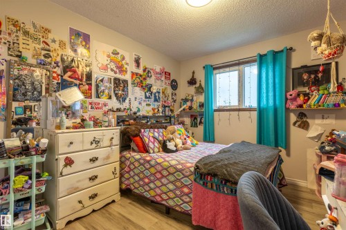 Room with wood-finish flooring and a single window - 8902 107 Avenue, Morinville, AB 