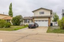Two-story residential exterior with light-colored siding and stone-look accents - 8902 107 Avenue, Morinville, AB 