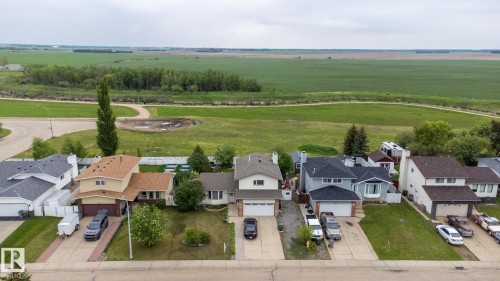 Residential neighborhood featuring established homes with attached garages, paved driveways, and mature landscaping - 8902 107 Avenue, Morinville, AB 