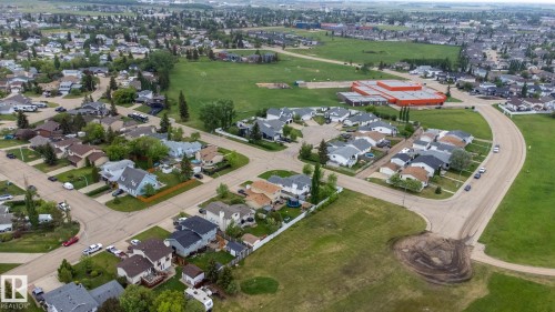 Aerial view of a residential area featuring multiple single-family homes with varying rooflines and exterior finishes - 8902 107 Avenue, Morinville, AB 