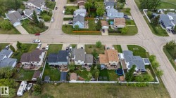 Aerial perspective showcasing a residential neighborhood with established homes and mature landscaping - 