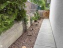 Gravel side yard with a concrete pathway leading to a wooden gate - 51 Glenmore Crescent, St. Albert, AB 