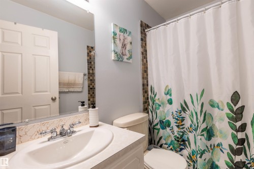 Vanity with integrated sink, chrome faucet, and decorative backsplash - 33 Andrew Crescent, St. Albert, AB 
