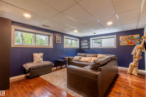 Recessed lighting illuminates this space featuring wood-finish flooring, a dropped ceiling, and multiple windows - 33 Andrew Crescent, St. Albert, AB 