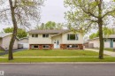 Split-level residence featuring light-colored siding and a brick-finish facade - 33 Andrew Crescent, St. Albert, AB 