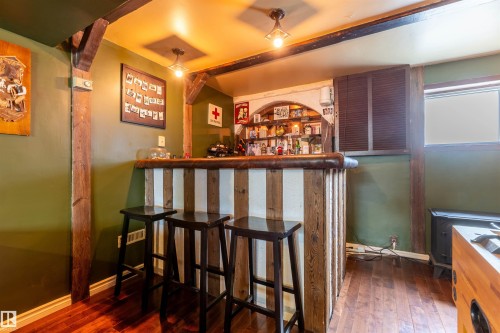 Custom bar with a rustic wood-finish top and striped paneling - 33 Andrew Crescent, St. Albert, AB 