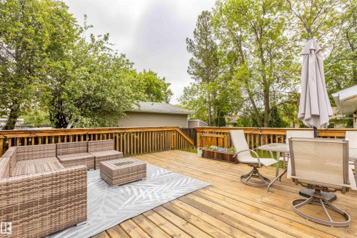 Spacious wooden deck featuring natural wood flooring and a perimeter railing - 33 Andrew Crescent, St. Albert, AB 