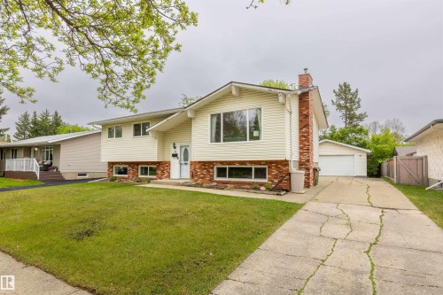 Split-level residence featuring white siding and a red brick facade - 33 Andrew Crescent, St. Albert, AB 