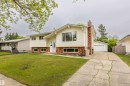 Split-level residence featuring white siding and a red brick facade - 33 Andrew Crescent, St. Albert, AB 