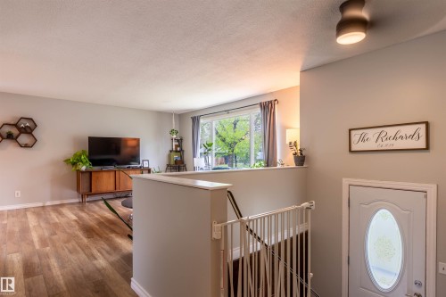 Entryway featuring a decorative oval-lite door and a contemporary flush-mount ceiling light - 33 Andrew Crescent, St. Albert, AB 