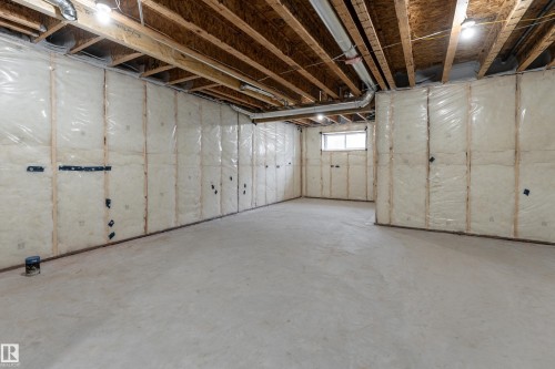 Expansive unfinished basement featuring a concrete floor, exposed wood ceiling joists, and insulated framed walls - 115 Garneau Gate, Spruce Grove, AB 