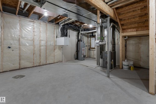 Open basement area featuring concrete flooring and exposed ceiling joists - 115 Garneau Gate, Spruce Grove, AB 