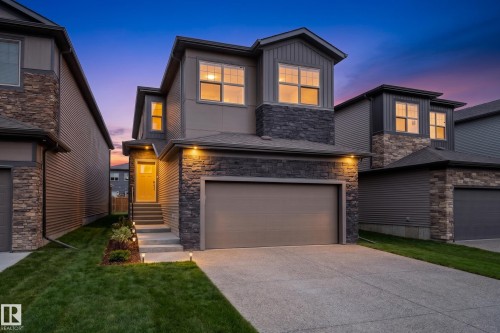 Contemporary exterior with stone veneer and horizontal siding accents - 115 Garneau Gate, Spruce Grove, AB 