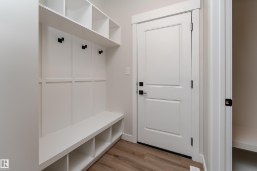 Built-in entryway storage bench with shelving and coat hooks - 115 Garneau Gate, Spruce Grove, AB 