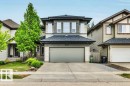Contemporary two-story residence featuring a two-car garage, partial stone facade, and a covered porch entry - 1107 Chahley Crest, Edmonton, AB 