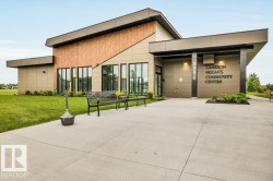 Modern architectural exterior featuring a blend of paneling and wood-finish siding - 