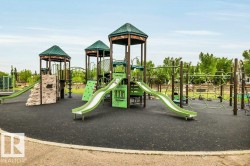 Expansive playground featuring multiple slides, climbing walls, monkey bars, and hexagonal platforms - 