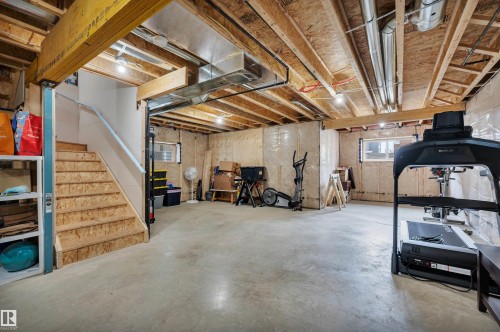Spacious unfinished basement featuring exposed wood joists and concrete flooring - 3898 Robins Crescent, Edmonton, AB 