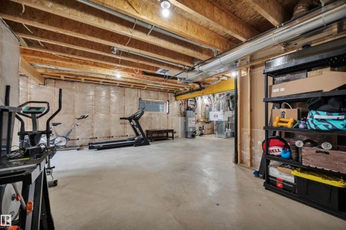 Unfinished basement featuring exposed wood joists, concrete flooring, and insulated perimeter walls - 3898 Robins Crescent, Edmonton, AB 