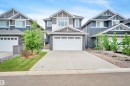 Contemporary two-story residence featuring a multi-textured facade with stone accents, horizontal siding, and gable rooflines - 3898 Robins Crescent, Edmonton, AB 