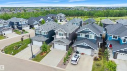 Modern residential neighborhood featuring diverse exterior architectural styles, attached garages, and concrete driveways - 