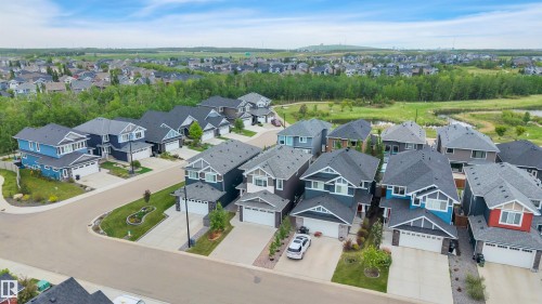 Aerial perspective of a modern residential development featuring multiple detached homes with diverse exterior finishes - 3898 Robins Crescent, Edmonton, AB 
