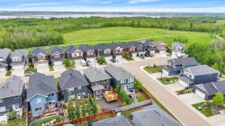 Residential properties with varied exterior finishes, attached garages, and private backyards - 