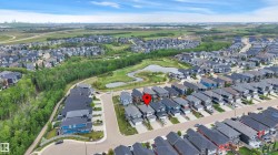 Residential neighborhood featuring diverse architectural styles, tree-lined streets, and multiple water features - 