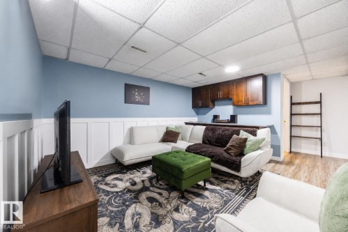 Finished basement space featuring wainscoting and a drop ceiling - 17932 93 Avenue, Edmonton, AB 