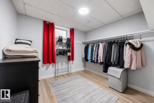 Spacious room featuring light wood-finish flooring and a drop ceiling - 17932 93 Avenue, Edmonton, AB 