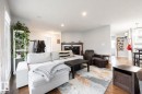 Inviting living space featuring wood-finish flooring, a fireplace with a dark wood mantel, recessed lighting, and light-toned walls - 17932 93 Avenue, Edmonton, AB 