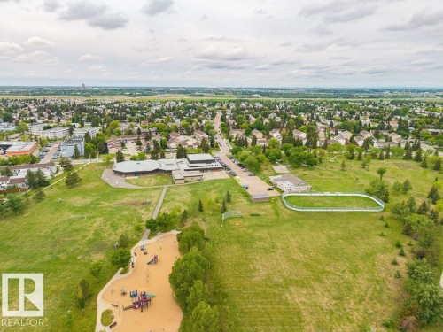 Expansive green space featuring a playground, sports field, and paved walking paths - 17932 93 Avenue, Edmonton, AB 