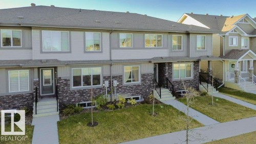 Contemporary multi-level townhome featuring a stone and siding facade - 1537 Sandstone Boulevard, Sherwood Park, AB - Outdoor With Facade