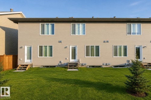 Rear exterior with light tan horizontal siding - 1537 Sandstone Boulevard, Sherwood Park, AB - Outdoor With Exterior